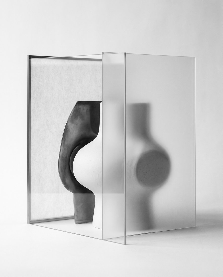Editorial illustration — a single sculptural object viewed through two slightly offset translucent planes; its contour changes with the angle but neither view is false. Conceptual monochrome study of two legitimate accounts of the same decision. Not documentary.